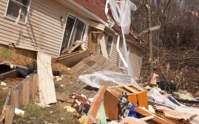 A Storm-damaged Michigan Home With Debris In The Front Yard, Requiring Professional Storm Damage Restoration.